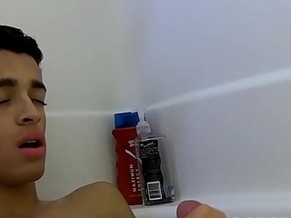 Cute young twink toying and arrhythmic off during hot bath